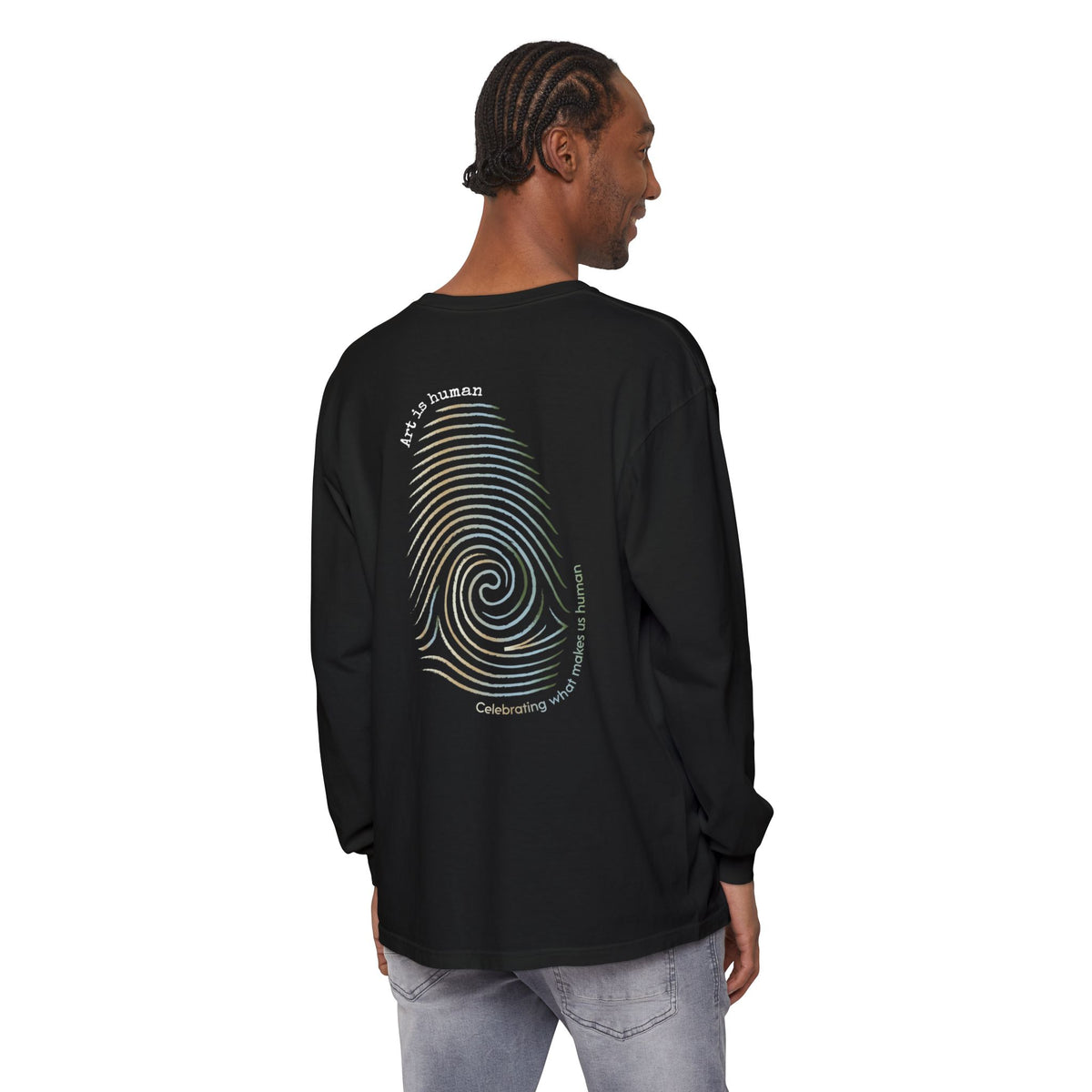 A black long-sleeve t-shirt shown from the back, featuring a large graphic print of a spiral fingerprint in a multi gradient with the text 'Art Is human' and 'Celebrating what makes us human'.