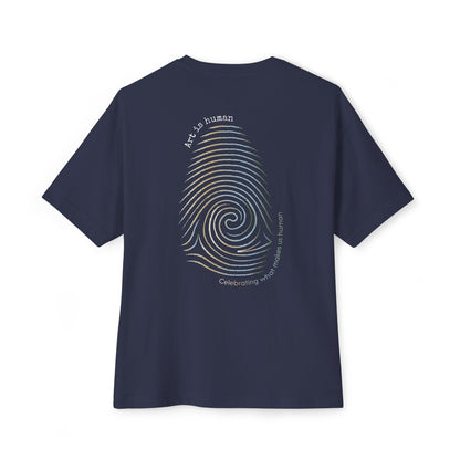 A navy short-sleeve t-shirt shown from the back, featuring a large graphic print of a spiral fingerprint in a multi gradient with the text 'Art Is human' and 'Celebrating what makes us human'.