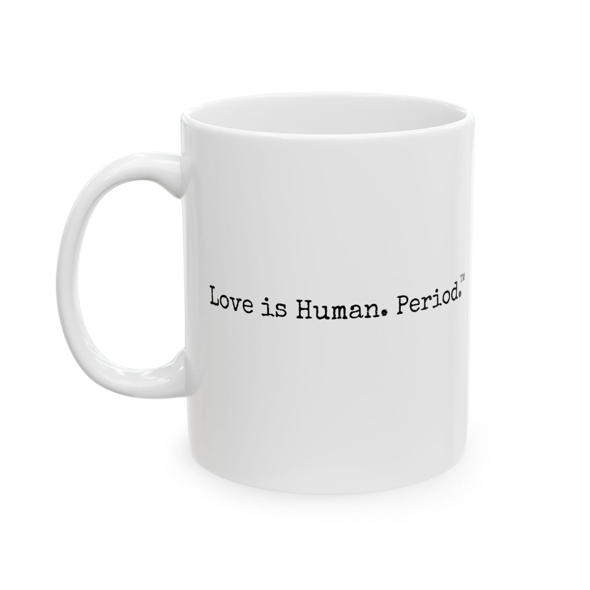 A white ceramic coffee mug with black printed text reading 'Love is Human. Period.