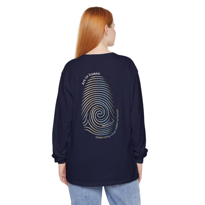 A navy long-sleeve t-shirt shown from the back, featuring a large graphic print of a spiral fingerprint in a multi gradient with the text 'Art Is human' and 'Celebrating what makes us human'.
