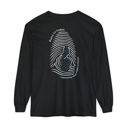 A black long-sleeve t-shirt with a large graphic on the back featuring a white fingerprint pattern, a blue treble clef, and white text that reads 'Music is human' and 'Celebrating what makes us human'.
