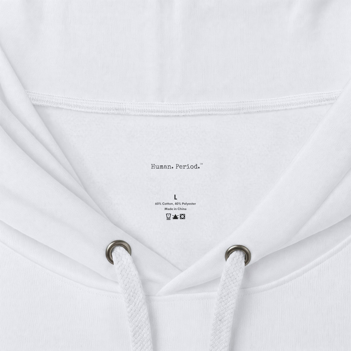 Close-up of a white hoodie showing the inside neck area, drawstrings, and printed inner label text reading 'Human, Period.' with size and care symbols.