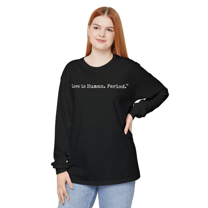 Person wearing a black long-sleeve shirt with 'Love is Human. Period.' text on a white background