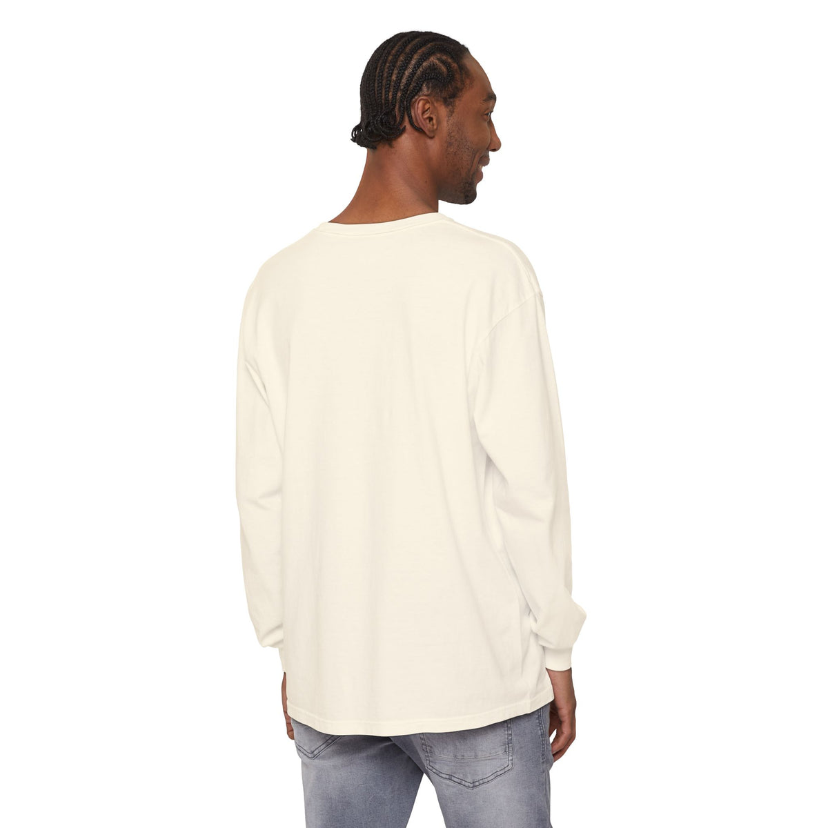 Man wearing a cream long-sleeve shirt and jeans on a white background