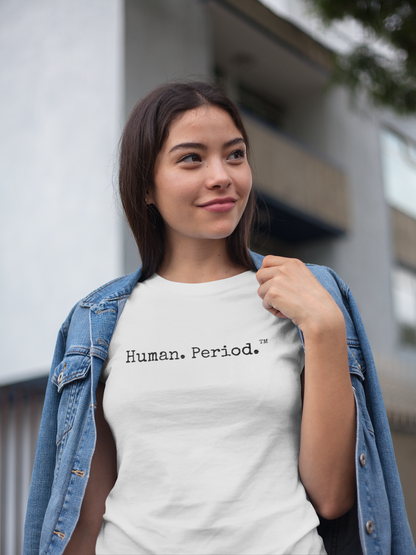 Woman wearing a white t-shirt with a Human. Period text standing outdoors