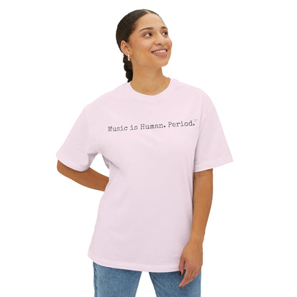 Woman wearing pink t-shirt with 'Music is Human. Period.' text on a white background