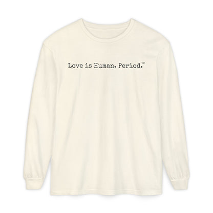 An off-white long-sleeve crewneck t-shirt with the text 'Love is Human. Period.' printed in black across the chest, displayed on a clean white background.