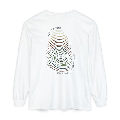 A white long-sleeve t-shirt shown from the back, featuring a colorful spiral fingerprint graphic with the text 'Art is human' and 'Celebrating what make us human'.