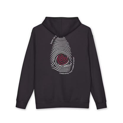 A black pullover hoodie shown from the back, featuring a large white fingerprint graphic with a red spiral center and white text reading Love is human