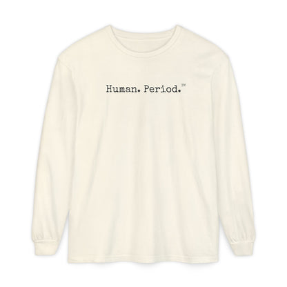 An off-white long-sleeve crewneck t-shirt with the text 'Human.Period.' printed  across the chest, displayed on a clean white background.