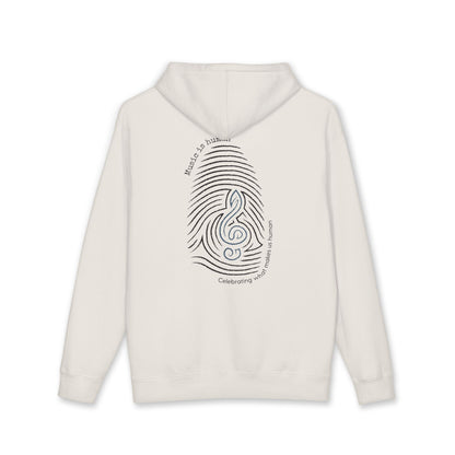 An off-white hooded sweatshirt shown from the back, featuring a black graphic of a fingerprint integrated with a treble clef and the words 'Music is life' and 'Celebrating what makes us human'.