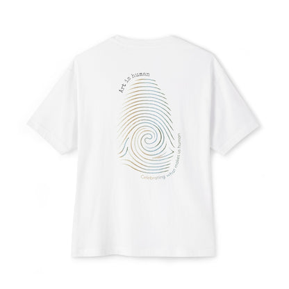 A white short-sleeve t-shirt shown from the back, featuring a large graphic print of a spiral fingerprint in a multi gradient with the text 'Art Is human' and 'Celebrating what makes us human'.