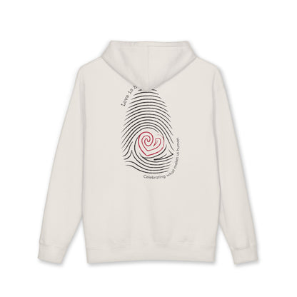 An off-white hooded sweatshirt shown from the back, featuring a graphic of a black fingerprint with a red spiral heart in the center and curved text reading 'Love is human